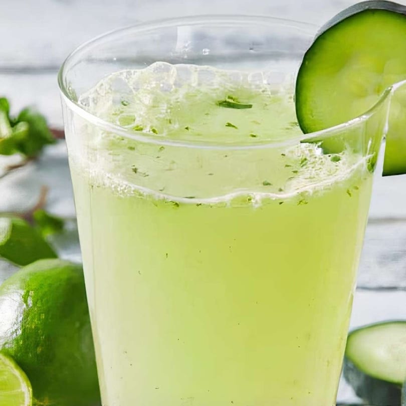 Refreshing cucumber lime agua fresca with mint, garnished with a cucumber slice.